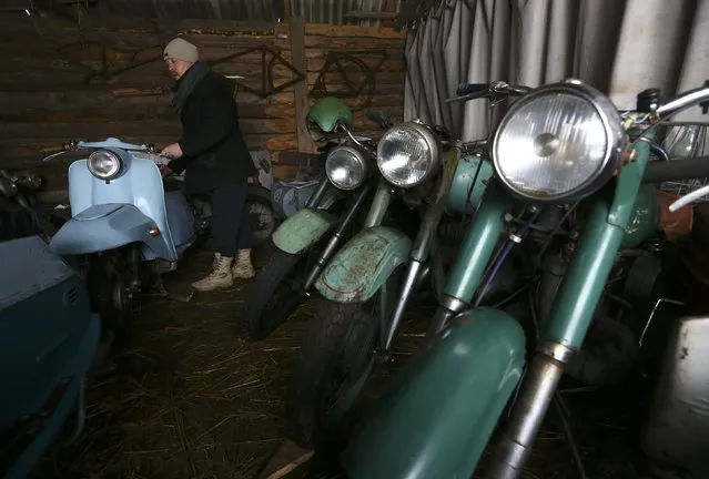 Collector Danila Tsitovich, who finds and restores old cars and motorcycles, shows collection of motorcycles at his base in the village of Zabroddzie, Belarus December 20, 2016. (Photo by Vasily Fedosenko/Reuters)