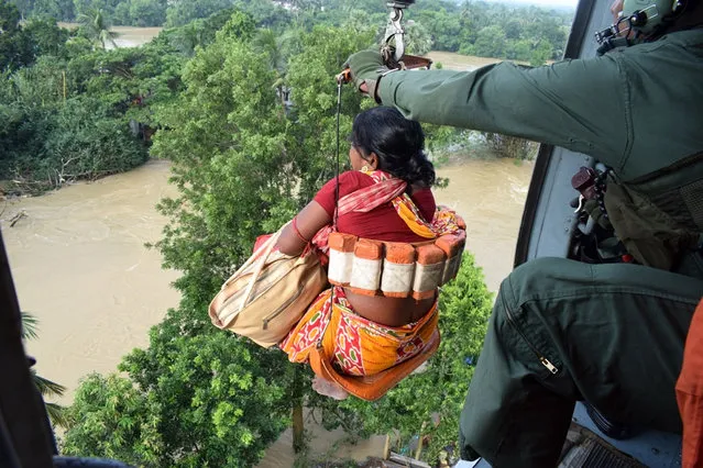 A handout photo made available by the Indian Air Force (IAF) showing an IAF helicopters during the rescue operation in flood affected areas of Dhanyaghari of Khanakul in West Bengal, India, 02 August 2021. According to the IAF, helicopters of Indian Air Force rescued 31 people from rooftops and brought them to safety to Arambaug. The helicopters also dropped emergency food supplies in the affected areas after the torrential rain in the state has thrown life out of gear and created flood like situation in many districts. (Photo by Indian Air Force/Handout via EPA/EFE)