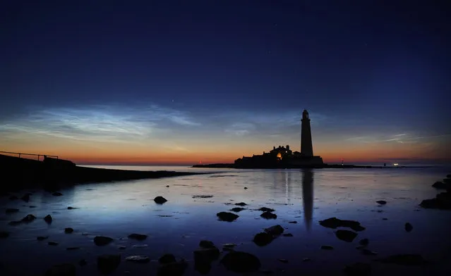 Noctilucent clouds over St Mary's Lighthouse near Whitley Bay in North Tyneside, Tyne and Wear, England on Friday, June 16, 2023. Noctilucent clouds are extremely rare very high clouds seen in the night sky, usually on clear, summer nights, one hour after sunset and an hour before sunrise when the sun sits between –6 and –10 degrees.They become visible about the same time as the brightest stars and are usually bluish or silver. (Photo by Owen Humphreys/PA Images via Getty Images)