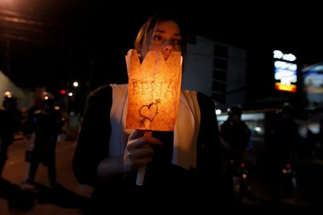 A woman holds a candle during a vigil to honour slain environmental rights activist Berta Caceres in Tegucigalpa, Honduras, March 4, 2016. (Photo by Jorge Cabrera/Reuters)