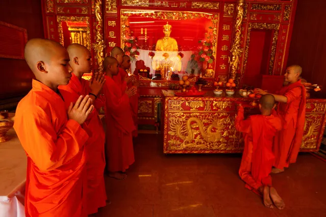 Buddhist monks pray inside a temple during the Lunar New Year eve celebration in Chinatown Bangkok, Thailand January 27 2017. (Photo by Jorge Silva/Reuters)