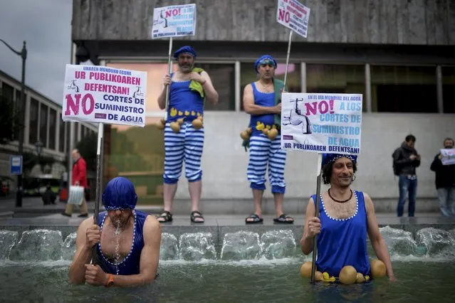 Protesters stand in a fountain holding signs reading “World Water Day. Defend Public Water. No To Water Service Cuts” on the United Nations World Water Day, in Bilbao March 22, 2016. (Photo by Vincent West/Reuters)