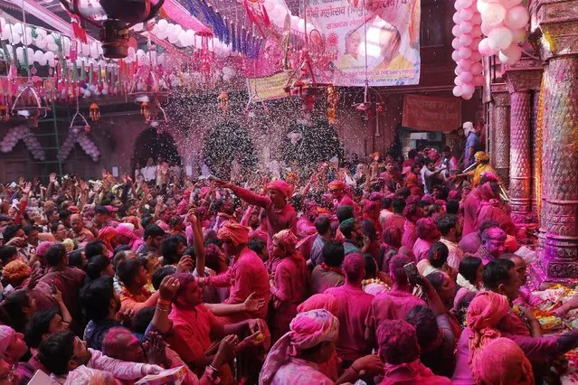 Revellers daubed in coloured powder take part in Holi celebrations, the Hindu spring festival of colours, at the Bankey Bihari temple in Vrindavan on March 23, 2024. (Photo by AFP Photo)