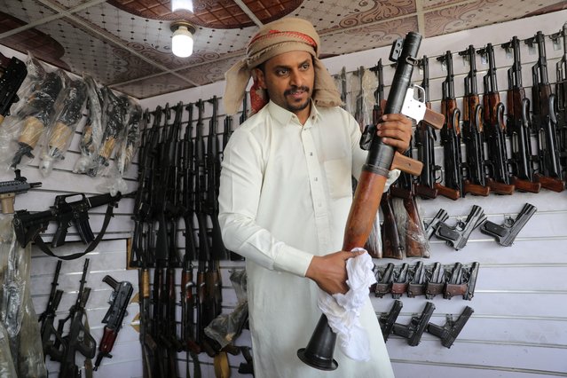 Arms dealer Qaed Elaiyan holds an RPG launcher at his shop, as the war in Gaza and the U.S.-led strikes on Houthi targets raise demand for firearms, in Sanaa, Yemen on March 6, 2024. (Photo by Khaled Abdullah/Reuters)