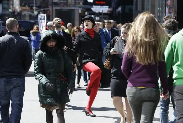 Jacqueline Sabulsky hands out flyers for the musical “Chicago” in Times Square in New York, Tuesday, March 29, 2016. The costumed characters, naked painted ladies and bus tour ticket sellers who have made all of Times Square their stomping grounds could be restricted to specific zones under legislation being considered by the City Council. The council's committee on transportation is holding a hearing Wednesday morning on legislation that would allow the city's Department of Transportation to create rules and regulations for pedestrian plazas like the ones in Times Square. (Photo by Seth Wenig/AP Photo)