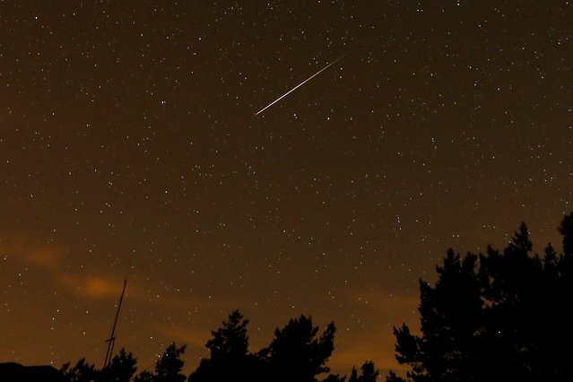 In this long exposure photo, a streak appears in the sky during the annual Perseid meteor shower at the Guadarrama mountains, near Madrid, in the early hours of August 12, 2016. The best viewing for the annual shower visible around the world will be from Saturday night, Aug. 12, 2023, local time, into early Sunday morning, when viewers might be able to spot a meteor per minute. (Photo by Francisco Seco/AP Photo)