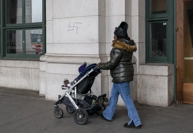 A hand-drawn swastika is seen on the front of Union Station near the Capitol in Washington, Friday, January 28, 2022. (Photo by J. Scott Applewhite/AP Photo)