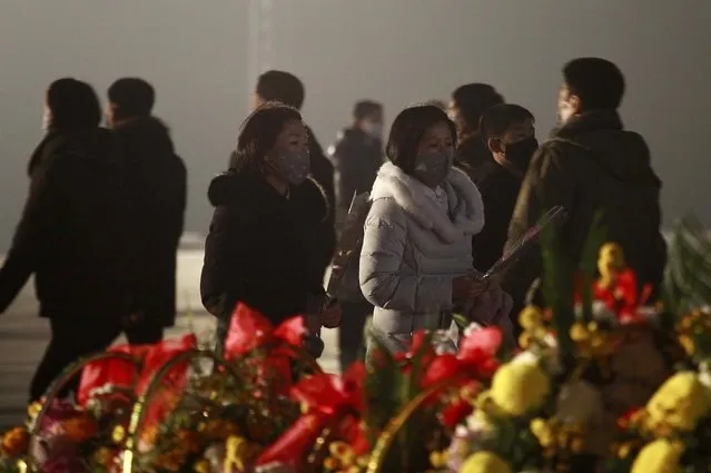 Citizens visit the bronze statues of their late leaders Kim Il Sung and Kim Jong Il on Mansu Hill in Pyongyang, North Korea Thursday, December 16, 2021, on the occasion of 10th anniversary of demise of Kim Jong Il. (Photo by Jon Chol Jin/AP Photo)
