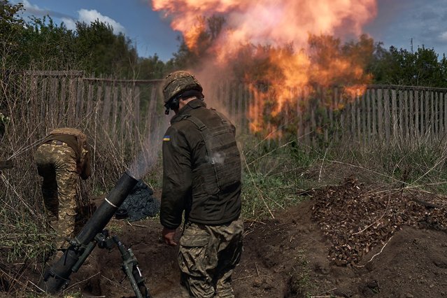 A mortar unit with a 120 mm mortar prepares to perform a combat mission on May 18, 2024 in the Kharkiv region, near the border with Russia. Ukrainian soldiers from the 92nd assault brigade were involved in holding back the Russians on the border with Russia. In recent days Russian forces have gained ground around the Kharkiv region, which Ukraine had largely reclaimed in the months following Russia's initial large-scale invasion in February 2022. (Photo by Kostiantyn Liberov/Libkos/Getty Images)
