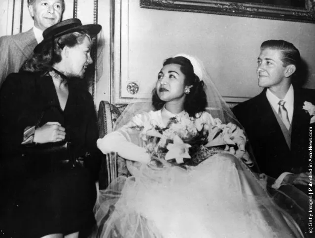 1950:  Princess Fatima of Persia and her bridegroom, American University graduate, Vincent Les Hillyer, at their Muslim wedding ceremony at the Persian Embassy in Paris. On the right is American film actress and dancer Rita Hayworth (1918 - 1987), Princess Aly Khan (born Margarita Carmen Cansino)