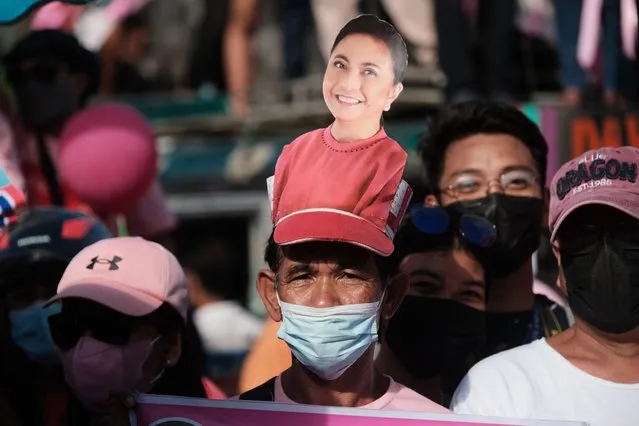 A man wears a cap with a photo of incumbent Vice-President and presidential hopeful Leni Robredo during a campaign rally in Iriga City, Camarines Sur, Philippines, Tuesday, February 8, 2022. Campaigning in the Philippines’ presidential election started Tuesday with a cast of candidates led by a late dictator’s son and the pro-democracy current vice president, with all vowing to bail out a country driven deeper into poverty by the pandemic and plagued by gaping inequalities and decades-long insurgencies. (Photo by John Michael Magdasoc/AP Photo)