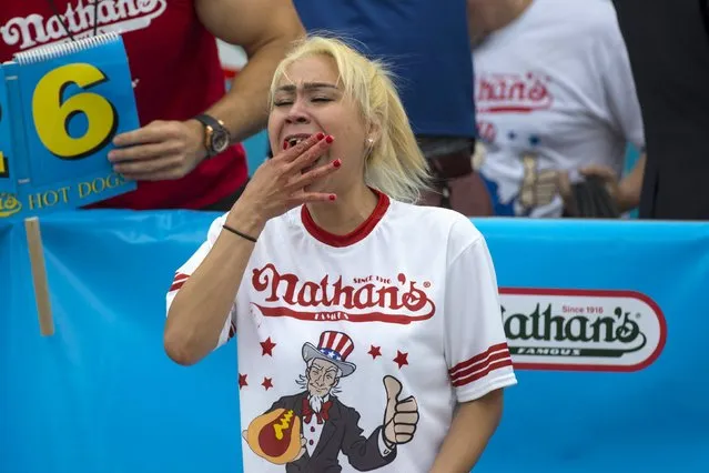 Miki Sudo, winner of Nathan's Famous Hot Dog Eating Contest in the Women's division, eats a hot dog during the competition in Brooklyn, New York July 4, 2015. Sudo finished with a total of 38 hot dogs consumed in ten minutes. (Photo by Andrew Kelly/Reuters)