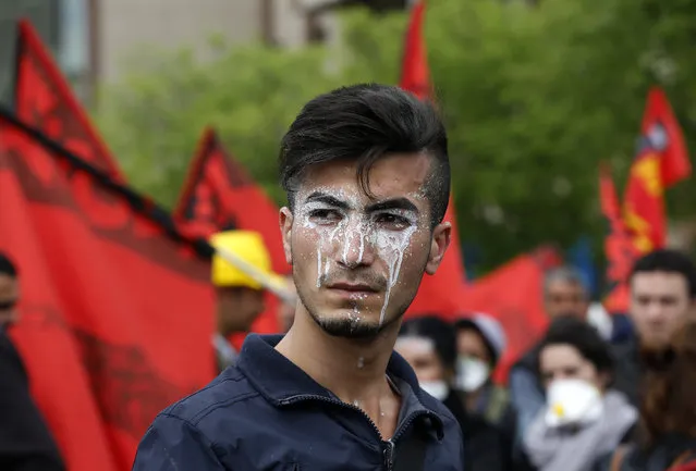 A protester, with cream applied to his face to protect against tear gas, reacts during a May Day demonstration in Istanbul May 1, 2014. Turkish police fired tear gas, water cannon and rubber pellets on Thursday to try to stop thousands of people, some armed with fire bombs and fireworks, from defying a ban on May Day rallies and reaching Istanbul's central Taksim square. (Photo by Umit Bektas/Reuters)