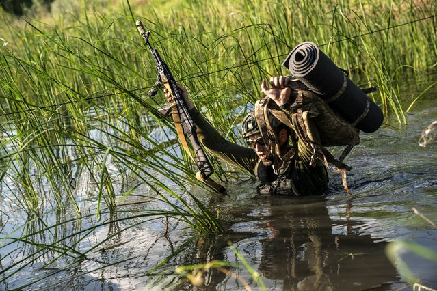 Ukrainian soldiers of the 22nd Infantry Brigade are seen in tactical training crossing a river in the direction of the Chasiv Yar, Donetsk Oblast in Ukraine, June 08, 2024. (Photo by Jose Colon/Anadolu via Getty Images)