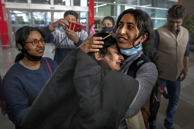 Mansi Singhal, an Indian student studying in Ukraine who fled the conflict, hugs her mother after she arrived at Indira Gandhi International Airport in New Delhi, India, Wednesday, March 2, 2022. (Photo by Altaf Qadri/AP Photo)