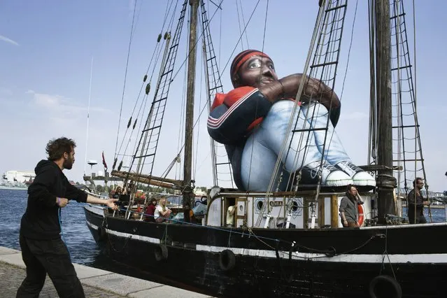The artwork “Inflatable Refugee” by Belgian artist collective Shellekens and Peleman on the deck of a wooden boat arrives in Copenhagen, Monday May 23, 2016. The creators say the artwork is a “symbol of the dehumanization of the refugee and the current refugee crisis happening in the world”. (Photo by Mathias Svold Maagaard/Polfoto via AP Photo)