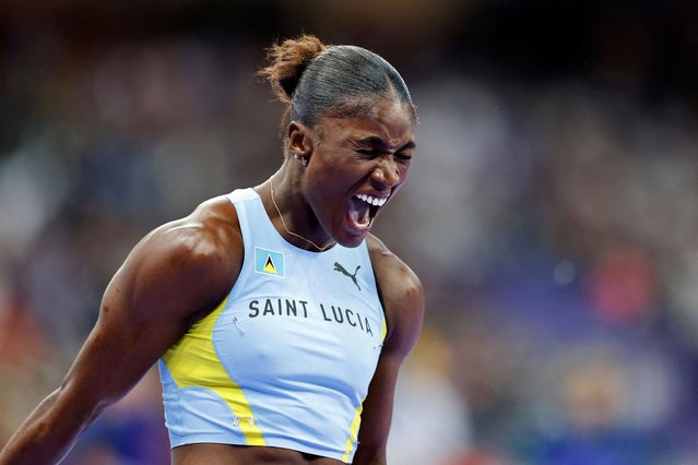 Saint Lucia's Julien Alfred celebrates after winning the women's 100m final of the athletics event at the Paris 2024 Olympic Games at Stade de France in Saint-Denis, north of Paris, on August 3, 2024. (Photo by Stefan Wermuth/Reuters)