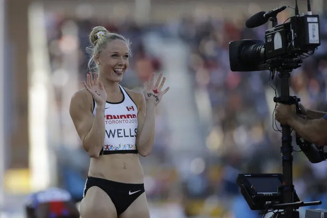 Canada's Sarah Wells gestures to a camera after the final of the women's 400 meter hurdles at the Pan Am Games Wednesday, July 22, 2015, in Toronto. Wells won the silver medal in the event. (Photo by Mark Humphrey/AP Photo)