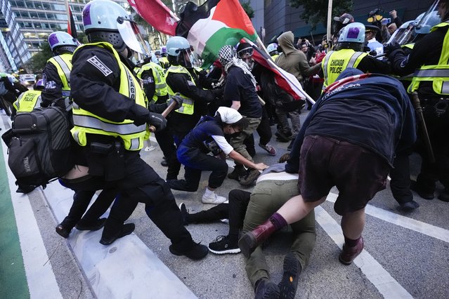 Demonstrators clash with police near the Israeli Consulate during the Democratic National Convention Tuesday, August 20, 2024, in Chicago. (Photo by Frank Franklin II/AP Photo)