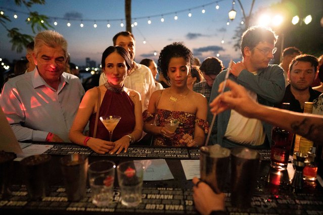 Members of the public line up for cocktails during the Havana Club Cocktail Maestros competition in Havana, Cuba, on April 17, 2024. (Photo by Alexandre Meneghini/Reuters)