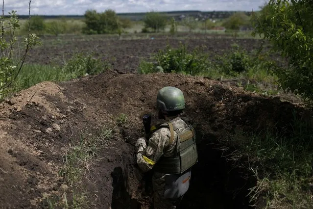 Ukrainian serviceman Shaba stays at a trench used as an observation point at a frontline area in Ruska Lozova, a village retaken by the Ukrainian forces, amid Russia's attack on Ukraine, in Kharkiv region, Ukraine, May 15, 2022. (Photo by Ricardo Moraes/Reuters)