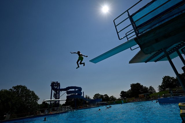 A person jumps into the Schafbergbad public pool during a heat wave, in Vienna, Austria on August 14, 2024. (Photo by Elisabeth Mandl/Reuters)