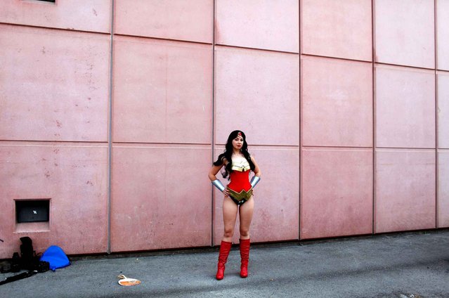 A woman dressed like the comic book character Wonder Woman poses for a picture during the 16th edition of the Japan Expo exhibition, in Villepinte, north of Paris, Thursday, July 2, 2015. (Photo by Thibault Camus/AP Photo)