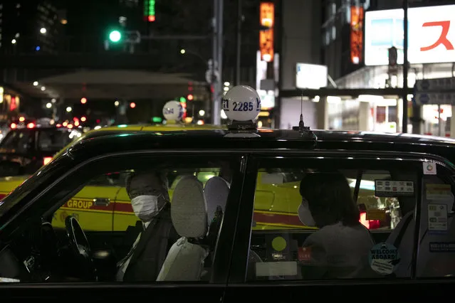 A taxi driver with a mask drops off a passenger near Ginza Station Thursday, January 30, 2020, in Tokyo. The country began evacuating Japanese citizens on Wednesday from the Chinese city Wuhan hardest-hit by the virus. (Photo by Jae C. Hong/AP Photo)