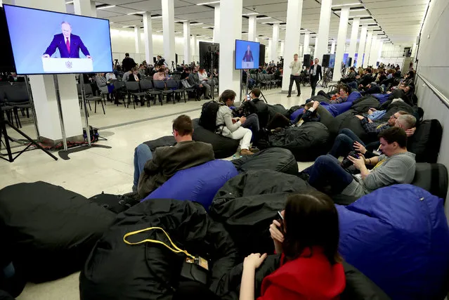 Journalists watching a live broadcast of Russian President Vladimir Putin's annual address to the Federal Assembly of the Russian Federation, at a media center at Moscow's Manezh Central Exhibition Hall in Moscow, Russia on January 15, 2020. (Photo by Mikhail Tereshchenko/TASS)