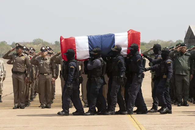 Members of the Thai special forces carry the coffin a fellow officer killed in a mass shooting, at a military airport in Nakhon Ratchasima, Thailand, Monday, February 10, 2020. (Photo by Sakchai Lalit/AP Photo)