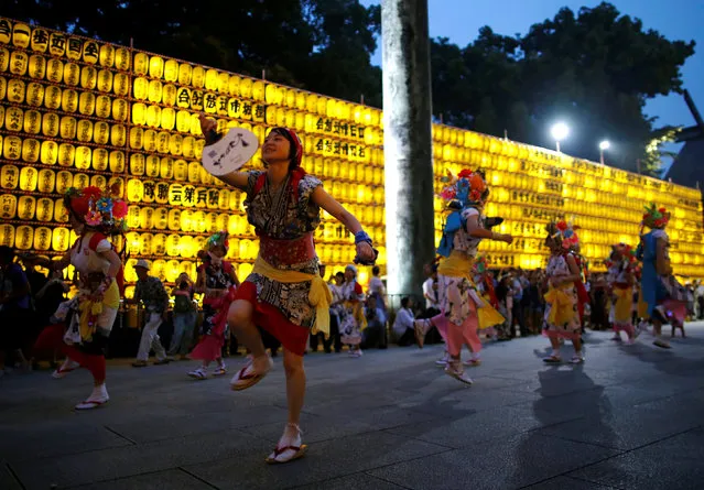 Dancers wearing traditional costumes perform Nebuta dance in front of thousands paper lanterns, which were displayed and lit up the precincts of the shrine, where more than 2.4 million war-dead are enshrined, during the Mitama Festival at Yasukuni Shrine in Tokyo, Japan July 13, 2016. (Photo by Issei Kato/Reuters)