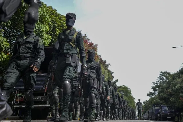 Army soldiers patrol outside parliament building in Colombo, Sri Lanka, Saturday, July 16, 2022. Sri Lankan lawmakers met Saturday to begin choosing a new leader to serve the rest of the term abandoned by the president who fled abroad and resigned after mass protests over the country's economic collapse. (Photo by Rafiq Maqbool/AP Photo)
