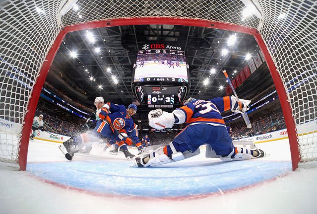 Isaiah George #36 and Ilya Sorokin #30 of the New York Islanders defend the net against the Seattle Kraken during the second period at UBS Arena on December 05, 2024 in Elmont, New York. (Photo by Bruce Bennett/Getty Images/AFP Photo)