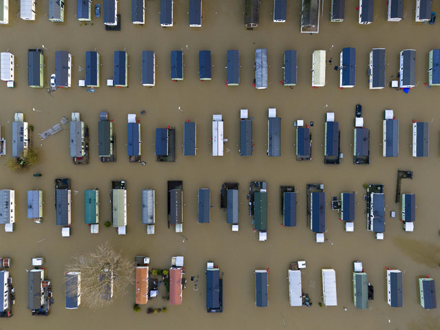 Caravans at Billing Aquadrome Holiday Park are surrounded by floodwaters brought by Storm Bert in Northampton, England, Monday, November 25, 2024. (Photo by Jordan Pettitt/PA Wire via AP Photo)