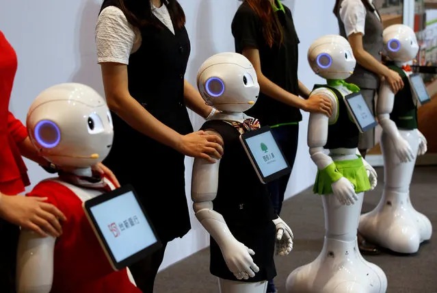 SoftBank's robots “Pepper”, dressed in different bank uniforms, are displayed during a news conference in Taipei, Taiwan July 25, 2016. (Photo by Tyrone Siu/Reuters)