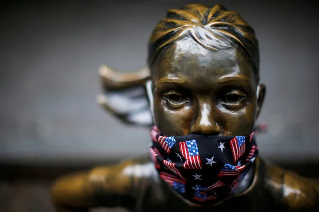 A protective mask is seen on the face of the “Fearless Girl” sculpture in the financial district, during the outbreak of the coronavirus disease (COVID-19) in New York City, New York, U.S. April 23, 2020. (Photo by Eduardo Munoz/Reuters)