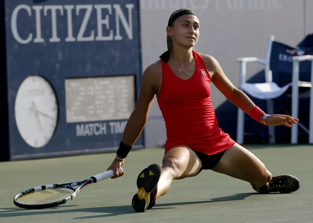 Aleksandra Krunic, of Serbia, slides on the court as she watches her shot fall against Madison Keys, of the United States, during the second round of the 2014 U.S. Open tennis tournament, Thursday, August 28, 2014, in New York. (Photo by Frank Franklin/AP Photo)