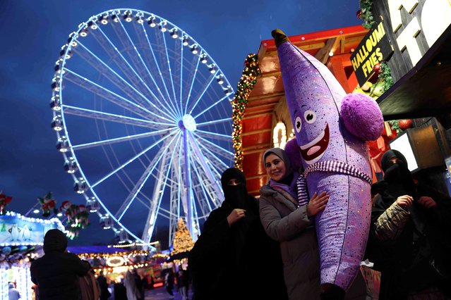 A visitor carries a soft toy prize through the Winter Wonderland theme park at Hyde Park in London, Britain on December 7, 2023. (Photo by Hannah McKay/Reuters)