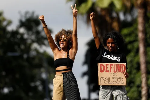 Women gesture during a protest outside of City Hall against racial inequality in the aftermath of the death in Minneapolis police custody of George Floyd in Los Angeles, California, U.S. June 6, 2020. (Photo by Patrick T. Fallon/Reuters)