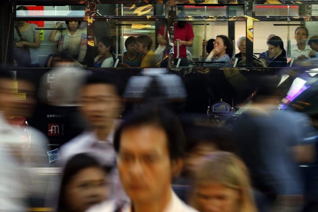 In this September 15, 2014, photo, passengers sit in a tram during a rush hour in Hong Kong. (Photo by Kin Cheung/AP Photo)