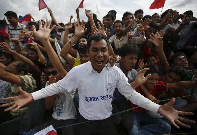 People cheer as they gather during a celebration a day after the first democratic constitution was announced in Kathmandu, Nepal September 21, 2015. (Photo by Navesh Chitrakar/Reuters)