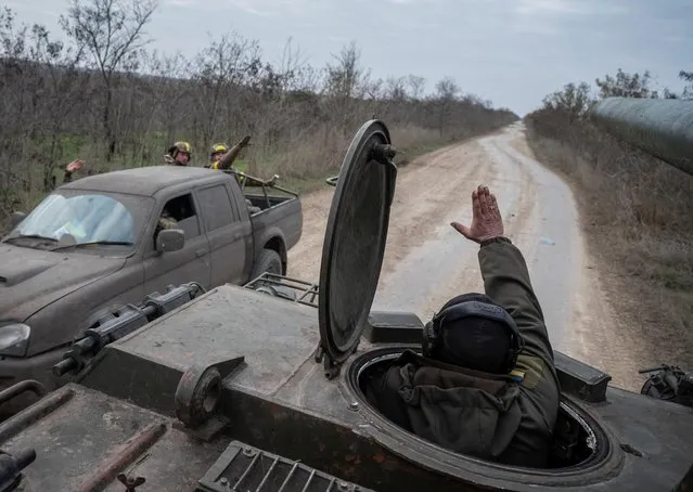 Ukrainian servicemen ride a 2S7 Pion self-propelled gun, as Russia's attack on Ukraine continues, near a frontline in Kherson region, Ukraine on November 9, 2022. (Photo by Viacheslav Ratynskyi/Reuters)