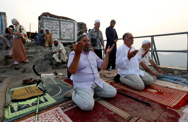 Muslim pilgrims pray at Mount Al-Noor, where Muslims believe Prophet Mohammad received the first words of the Koran through Gabriel in the Hera cave, ahead of the annual haj pilgrimage in the holy city of Mecca, Saudi Arabia September 7, 2016. (Photo by Ahmed Jadallah/Reuters)