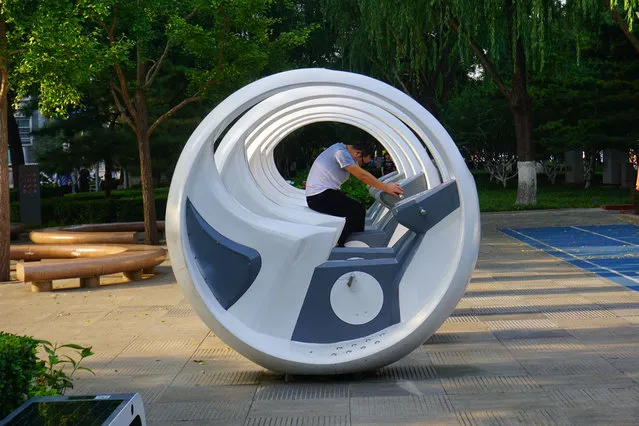 A man rides a smart trainer at Shuncheng park on August 6, 2020 in Beijing, China. (Photo by Liu Hongsheng/Qianlong.com/VCG via Getty Images)