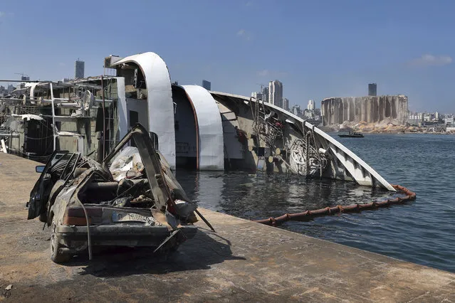 A sunken tourist ship and a damaged car are seen at the site of the Aug. 4 explosion that hit the seaport of Beirut, Lebanon, Saturday, August 15, 2020. (Photo by Bilal Hussein/AP Photo)