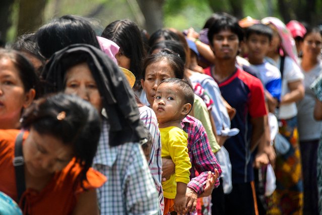 People queue for donated relief supplies following a strong earthquake in Mandalay, Myanmar, on April 3, 2025. (Photo by Reuters/Stringer)