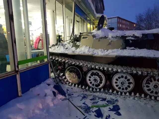 A view shows the scene of an incident involving an armoured personnel carrier (APC) which was rammed by a man into a shop window, before he climbed through the rubble to steal a bottle of wine, in the town of Apatity, Russia January 10, 2018. (Photo by Albert Borkin/Reuters)