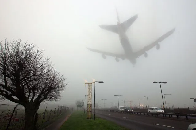 Planes land in fog at Heathrow Airport, west London on January 4, 2014, as heavy fog covers a many parts of the south east. (Photo by Steve Parsons/PA Images via Getty Images)