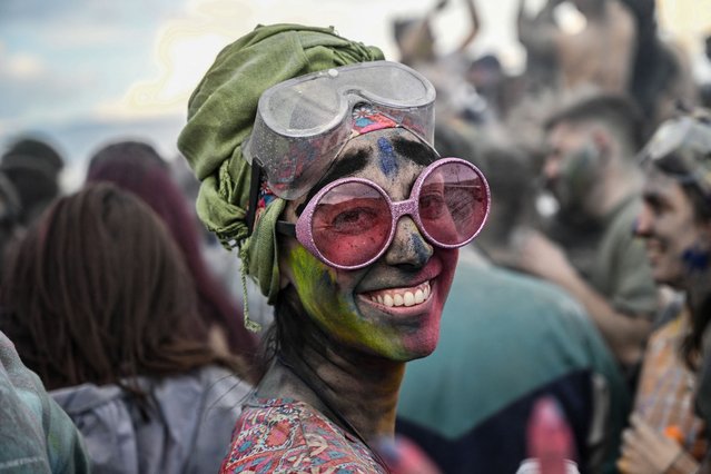 A reveller poses for a picture as she takes part in the traditional “Flour War” marking the 'Clean Monday' in the town of Galaxidi, central Greece, on March 18, 2024. This annual custom, which originated in the 19th century at the end of the carnival season, always falls on the “Clean Monday”, the public holiday that marks the start of the  Great Lent. (Photo by Aris Messinis/AFP)