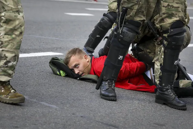 Riot police officers detain a protester during a Belarusian opposition supporters' rally protesting the official presidential election results in Minsk, Belarus, Sunday, September 13, 2020. (Photo by AP Photo/Stringer)